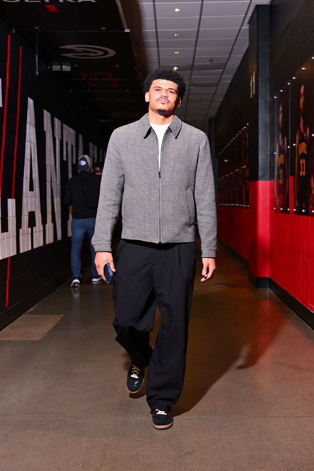 RayJ Dennis walking through an arena tunnel